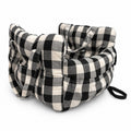 Pet car bed in black check on a white background, with carry handles and side pockets
