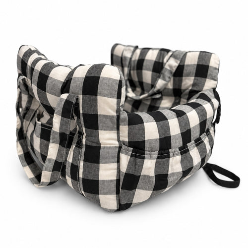 Pet car bed in black check on a white background, with carry handles and side pockets