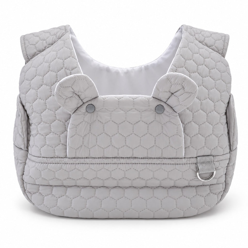 Light gray quilted front carrier with front flap and metal ring, front view on white