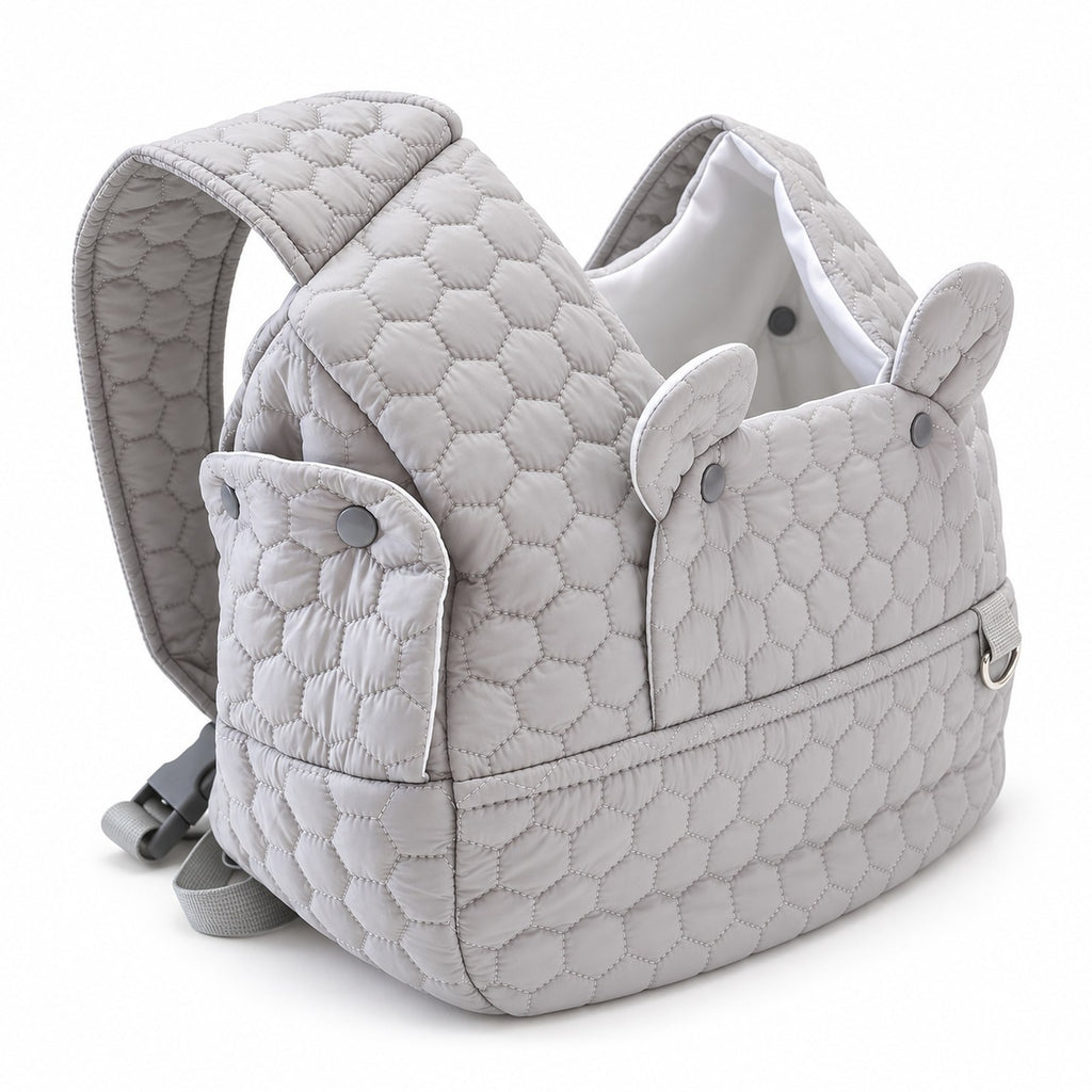 Three-quarter view of the quilted front carrier with snap side panels and shoulder straps