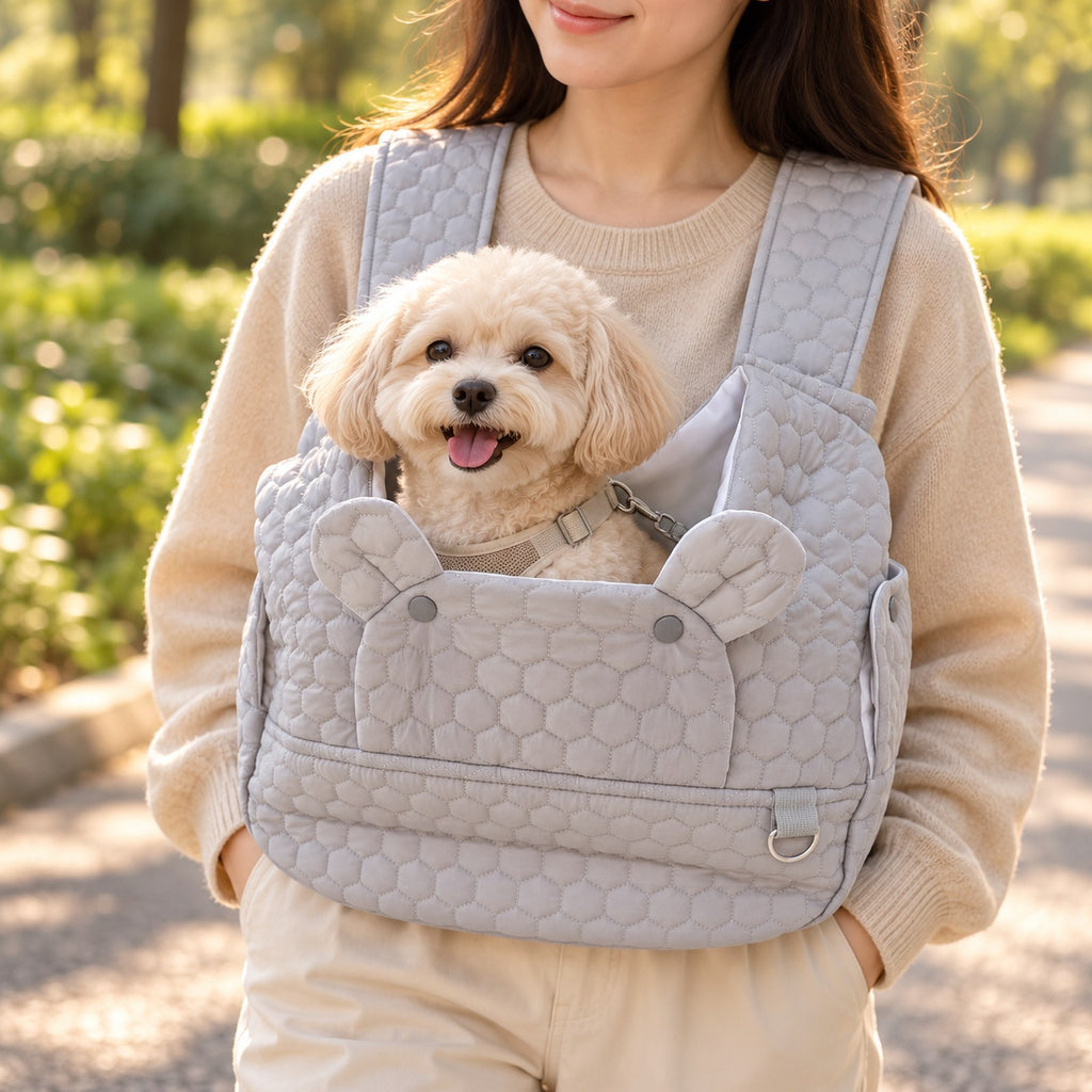 Close view of a small dog in the quilted front carrier worn at the chest