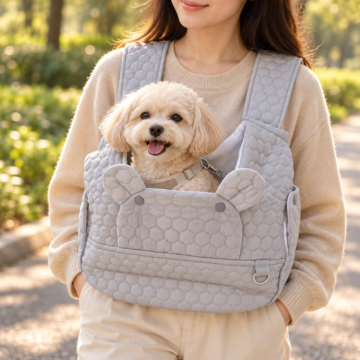 Close view of a small dog in the quilted front carrier worn at the chest
