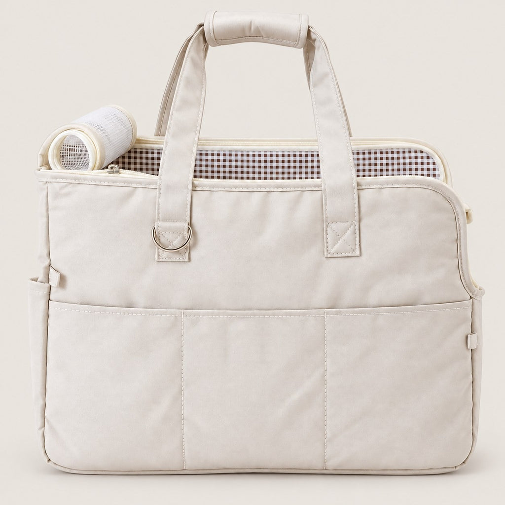 Beige pet travel tote on a warm gray background